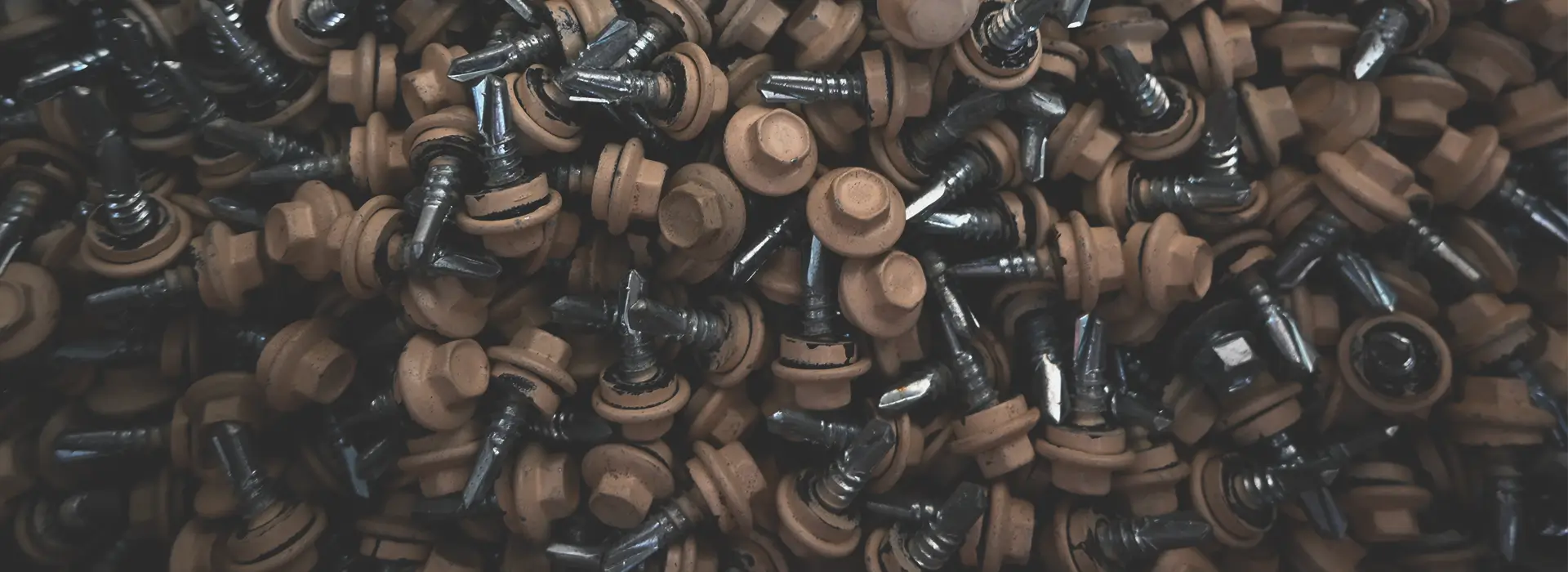Colored metal screws with various finishes used in metal building construction