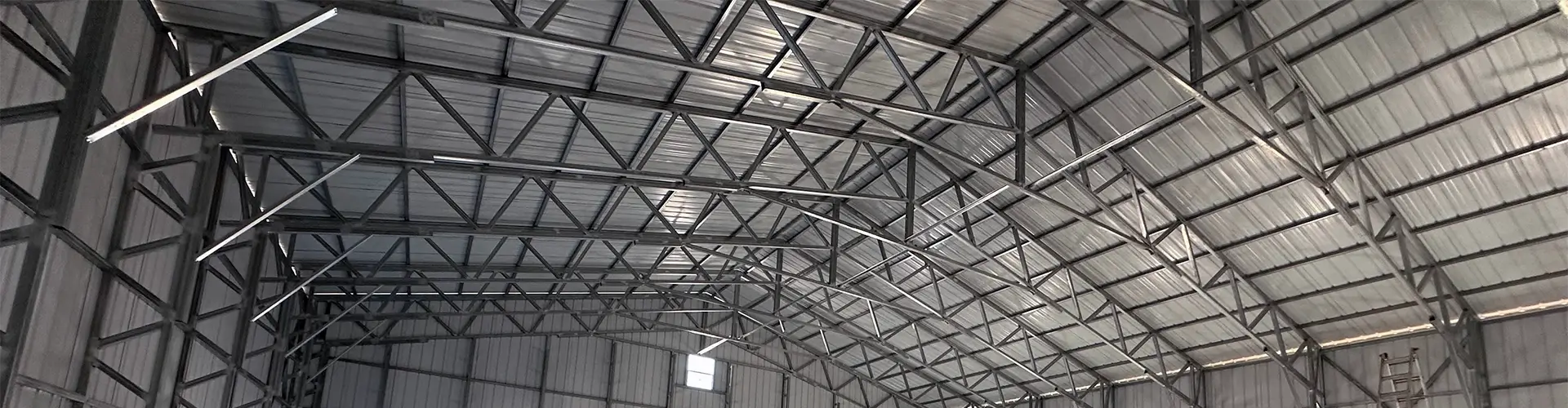 East Texas Carports metal frame structure inside a building.