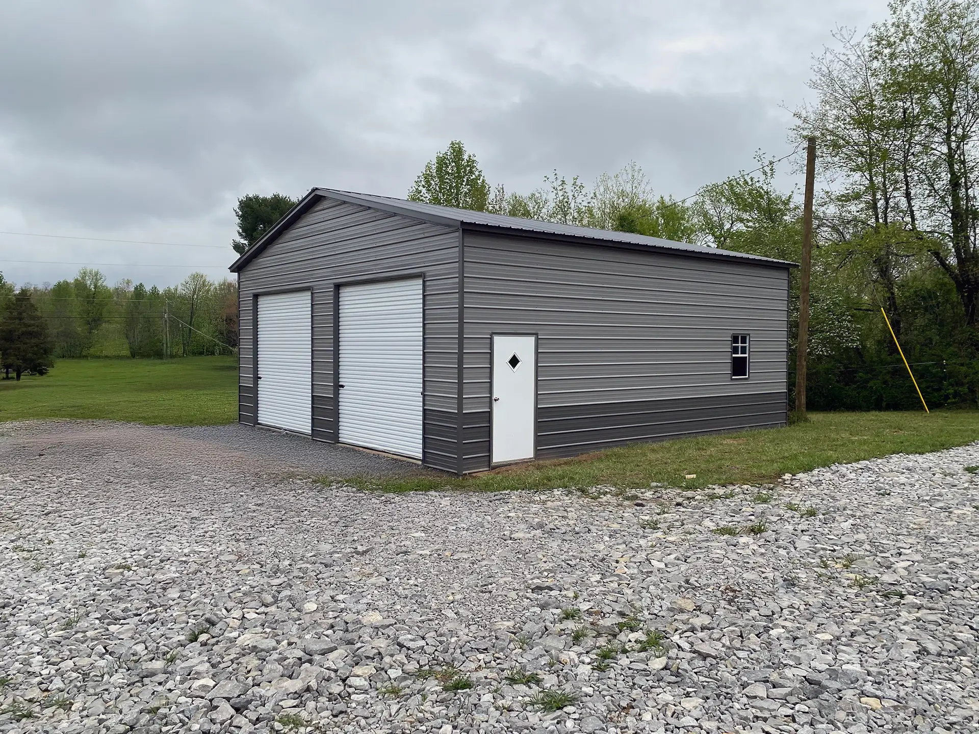 2 bay garage with zinc gray siding and brushed slate roof and trim.